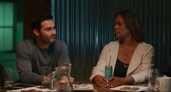 Movie still from “Can You Keep a Secret?” (2019), directed by Elise Durán – A man and a woman sitting at a dinner table; Medium shot, Over the shoulder angle