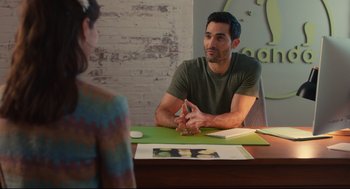 Movie still from “Can You Keep a Secret?” (2019), directed by Elise Durán – A man and a woman are sitting at a table talking; Medium shot, Over the shoulder angle
