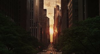 Movie still from “Can You Keep a Secret?” (2019), directed by Elise Durán – The sun is setting over a busy city street; Extreme Wide shot, High angle