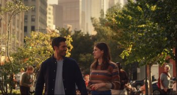 Movie still from “Can You Keep a Secret?” (2019), directed by Elise Durán – A man and a woman are holding hands and smiling; Medium shot, Over the shoulder angle