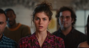 Movie still from “Can You Keep a Secret?” (2019), directed by Elise Durán – A young woman with blue eyes wearing a floral shirt; Close Up shot, Over the shoulder angle