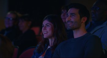 Movie still from “Can You Keep a Secret?” (2019), directed by Elise Durán – A man and a woman are sitting in a theater; Medium shot, Low angle