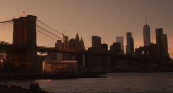 Movie still from “Can You Keep a Secret?” (2019), directed by Elise Durán – A view of a city skyline at sunset; Extreme Wide shot, Low angle