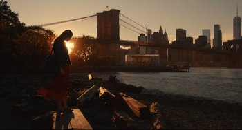 Movie still from “Can You Keep a Secret?” (2019), directed by Elise Durán – A woman standing on a pier near a body of water; Extreme Wide shot, Low angle