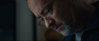 Movie still from “Captain Phillips” (2013), directed by Paul Greengrass – A person wearing glasses; Extreme Close Up shot, Low angle