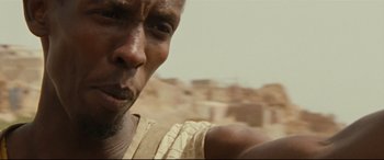 Movie still from “Captain Phillips” (2013), directed by Paul Greengrass – A man's face in the desert; Close Up shot, Low angle