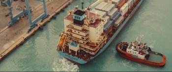 Movie still from “Captain Phillips” (2013), directed by Paul Greengrass – A large blue boat in a body of water; Extreme Wide shot, Overhead angle