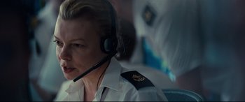 Movie still from “Captain Phillips” (2013), directed by Paul Greengrass – A woman wearing a headset and a uniform; Close Up shot, Low angle