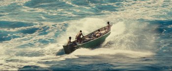 Movie still from “Captain Phillips” (2013), directed by Paul Greengrass – A group of people in a boat in the water; Extreme Wide shot, High angle