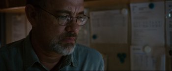Movie still from “Captain Phillips” (2013), directed by Paul Greengrass – An older man with glasses is looking at the camera; Close Up shot, Low angle