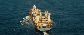 Movie still from “Captain Phillips” (2013), directed by Paul Greengrass – A large cargo ship sailing in the middle of the ocean; Extreme Wide shot, Overhead angle