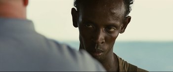 Movie still from “Captain Phillips” (2013), directed by Paul Greengrass – A man's face as he stares into the distance; Close Up shot, Over the shoulder angle
