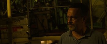 Movie still from “Captain Phillips” (2013), directed by Paul Greengrass – An older man with glasses is looking at the camera; Close Up shot, Over the shoulder angle