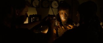 Movie still from “Captain Phillips” (2013), directed by Paul Greengrass – A man with a knife in his hand is looking at a clock; Close Up shot, Low angle