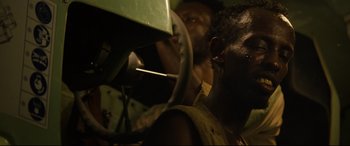 Movie still from “Captain Phillips” (2013), directed by Paul Greengrass – Two men working on a machine in a room; Close Up shot, Over the shoulder angle