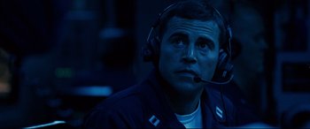 Movie still from “Captain Phillips” (2013), directed by Paul Greengrass – A man with a headset is sitting in a dark room; Close Up shot, Over the shoulder angle