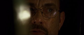 Movie still from “Captain Phillips” (2013), directed by Paul Greengrass – A person wearing glasses; Extreme Close Up shot, Over the shoulder angle
