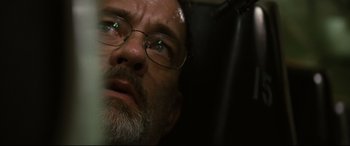 Movie still from “Captain Phillips” (2013), directed by Paul Greengrass – A person wearing glasses and a beard; Extreme Close Up shot, Low angle