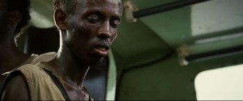 Movie still from “Captain Phillips” (2013), directed by Paul Greengrass – A man's face in a room; Close Up shot, Low angle