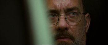 Movie still from “Captain Phillips” (2013), directed by Paul Greengrass – A person wearing glasses; Extreme Close Up shot, Over the shoulder angle