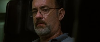 Movie still from “Captain Phillips” (2013), directed by Paul Greengrass – An older man with glasses is crying; Close Up shot, Low angle