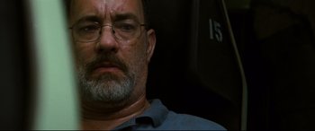 Movie still from “Captain Phillips” (2013), directed by Paul Greengrass – A man with a beard and glasses is looking straight ahead; Close Up shot, Low angle