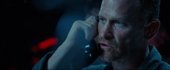 Movie still from “Captain Phillips” (2013), directed by Paul Greengrass – A person talking on a cell phone; Close Up shot, Low angle