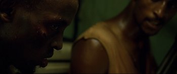 Movie still from “Captain Phillips” (2013), directed by Paul Greengrass – A man's face and shoulder; Close Up shot, Over the shoulder angle