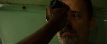 Movie still from “Captain Phillips” (2013), directed by Paul Greengrass – A man with a beard is holding a video game controller in front of his face; Close Up shot, Low angle