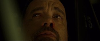 Movie still from “Captain Phillips” (2013), directed by Paul Greengrass – A man's eyes with a mustache; Extreme Close Up shot, Overhead angle