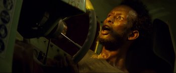 Movie still from “Captain Phillips” (2013), directed by Paul Greengrass – A person driving a car; Close Up shot, Low angle