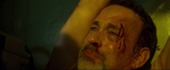Movie still from “Captain Phillips” (2013), directed by Paul Greengrass – A person with a knife on his face; Close Up shot, High angle