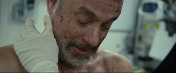 Movie still from “Captain Phillips” (2013), directed by Paul Greengrass – A person with blood all over his face; Close Up shot, Overhead angle