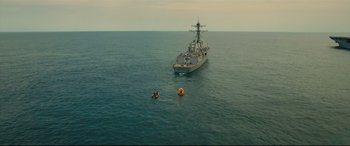 Movie still from “Captain Phillips” (2013), directed by Paul Greengrass – A person in the water next to a large boat; Extreme Wide shot, High angle