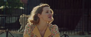 Movie still from “The Zookeeper's Wife” (2017), directed by Niki Caro – A woman in a yellow and orange floral shirt; Close Up shot, Low angle