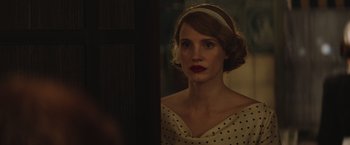 Movie still from “The Zookeeper's Wife” (2017), directed by Niki Caro – A woman in a polka dot dress looking into a mirror; Close Up shot, Over the shoulder angle