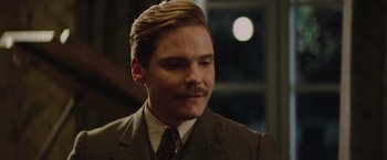 Movie still from “The Zookeeper's Wife” (2017), directed by Niki Caro – A man in a suit and tie with a mustache; Close Up shot, Low angle
