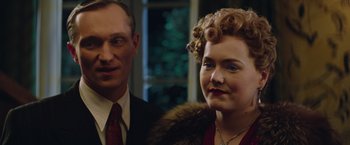 Movie still from “The Zookeeper's Wife” (2017), directed by Niki Caro – A man and a woman standing next to each other; Close Up shot, Over the shoulder angle