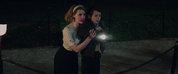 Movie still from “The Zookeeper's Wife” (2017), directed by Niki Caro – A woman and a young boy holding a flashlight in the dark; Medium shot, High angle