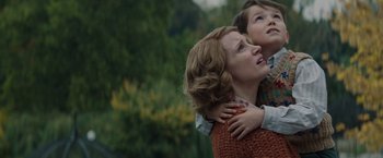 Movie still from “The Zookeeper's Wife” (2017), directed by Niki Caro – A woman and a child are hugging in a park; Medium shot, Low angle