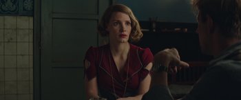 Movie still from “The Zookeeper's Wife” (2017), directed by Niki Caro – A woman sitting in a room with a dog; Medium shot, Over the shoulder angle