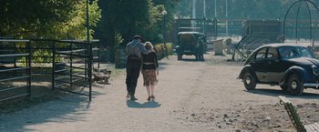 Movie still from “The Zookeeper's Wife” (2017), directed by Niki Caro – A man and a woman walking down a street; Wide shot, High angle