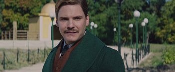 Movie still from “The Zookeeper's Wife” (2017), directed by Niki Caro – A person wearing a suit and tie; Close Up shot, Low angle