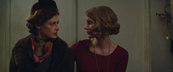 Movie still from “The Zookeeper's Wife” (2017), directed by Niki Caro – Two women are standing next to each other in a room; Close Up shot, Over the shoulder angle