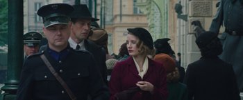 Movie still from “The Zookeeper's Wife” (2017), directed by Niki Caro – A man and a woman in a crowd of people; Medium shot, Low angle