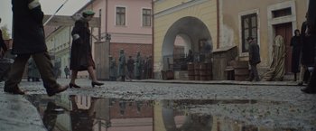 Movie still from “The Zookeeper's Wife” (2017), directed by Niki Caro – A group of men in uniforms are standing in front of a building; Wide shot, High angle