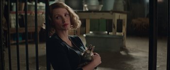 Movie still from “The Zookeeper's Wife” (2017), directed by Niki Caro – A woman holding a rabbit in her arms; Close Up shot, Over the shoulder angle
