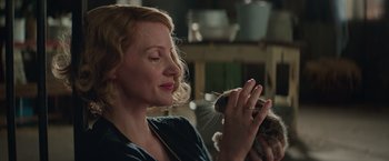 Movie still from “The Zookeeper's Wife” (2017), directed by Niki Caro – A woman holding a cat up to her face; Close Up shot, Over the shoulder angle