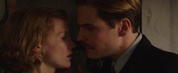 Movie still from “The Zookeeper's Wife” (2017), directed by Niki Caro – A man and a woman face to face in a dark room; Close Up shot, Low angle
