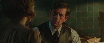 Movie still from “The Zookeeper's Wife” (2017), directed by Niki Caro – A man wearing glasses and a vest is talking to a woman; Close Up shot, Over the shoulder angle
